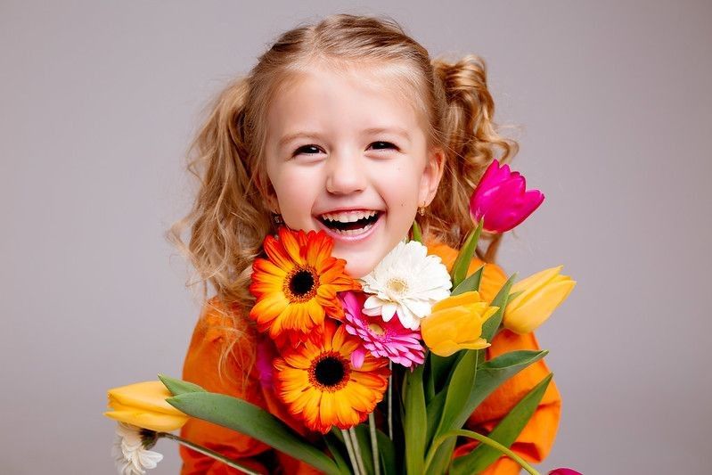 Happy girl with flower bouquet