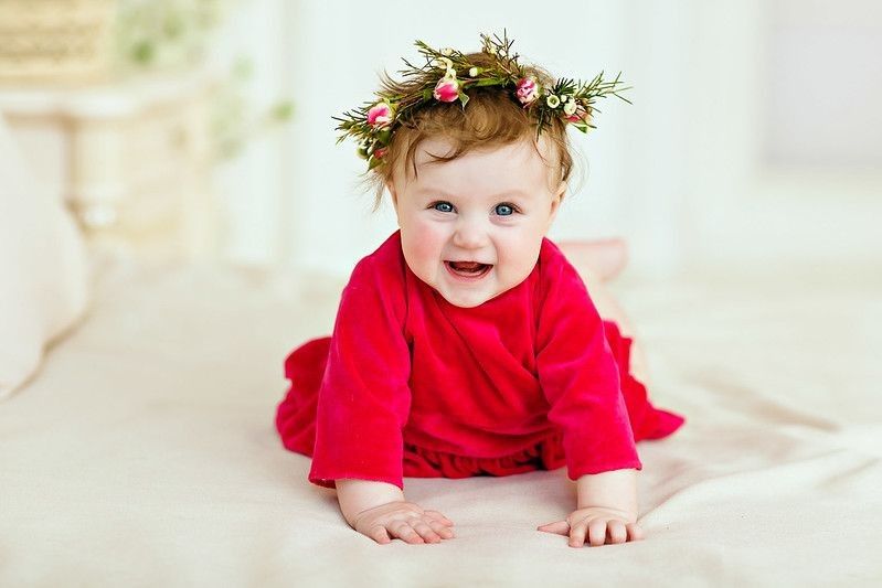 Smiling baby wearing red dress and flower tiara - Nicknames