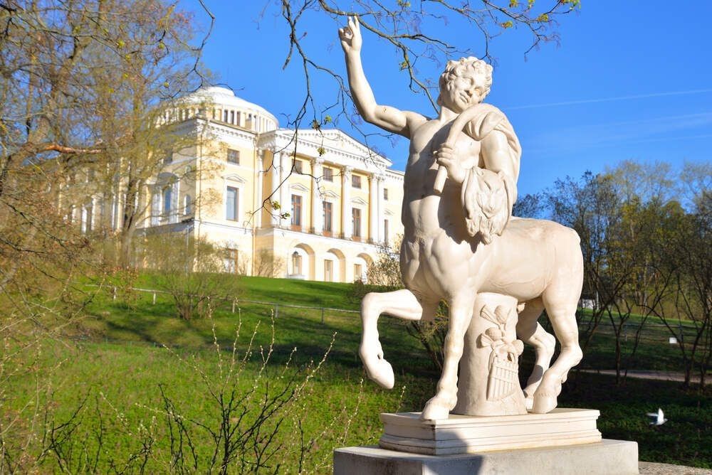 A centaur statue and palace in the background