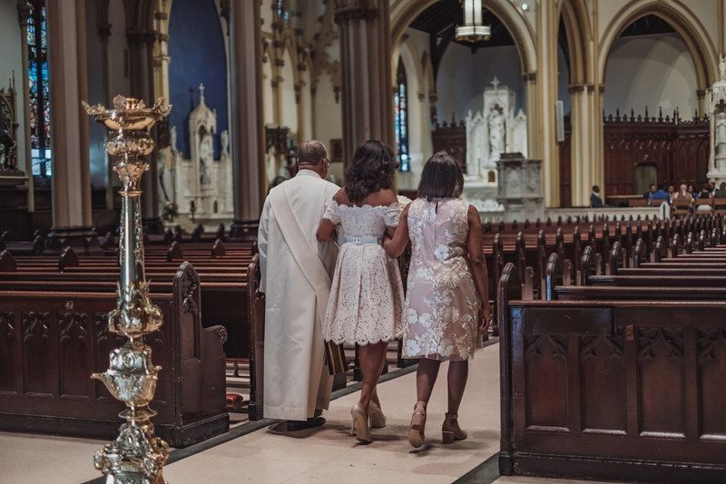 Family going to ceremony in catholic church