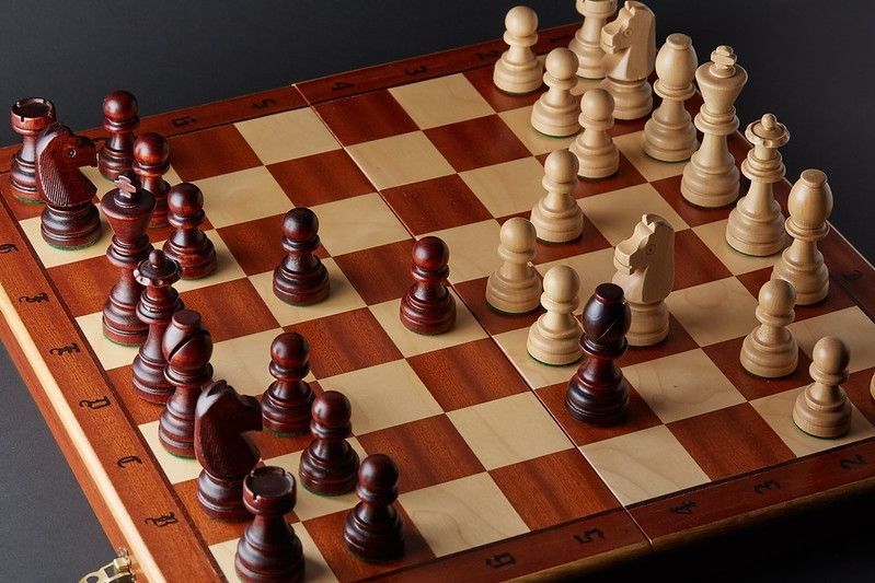 Wooden Chessboard with chess pieces.