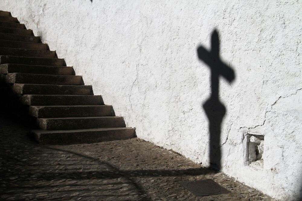 Shadow of a religious cross on the wall in Ronda, Spain.