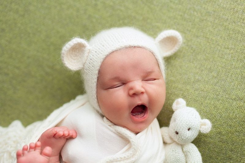 Adorable newborn baby wearing white rabbit hat is yawning - Nicknames