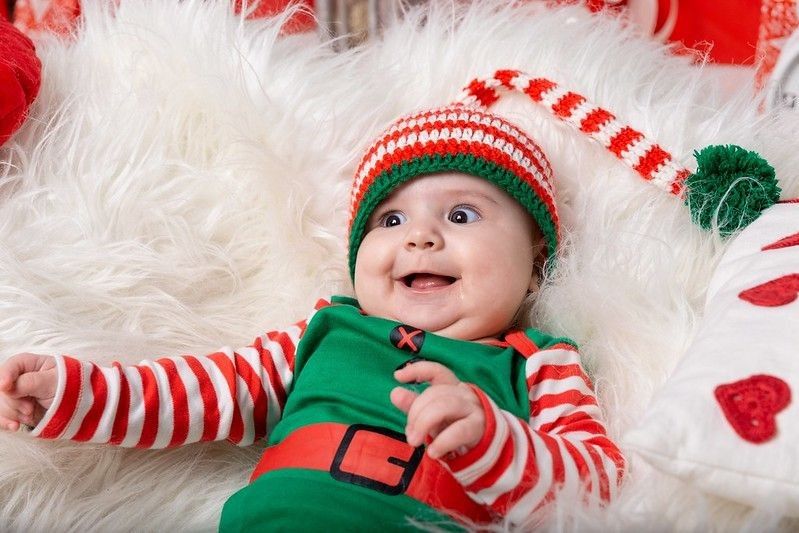 Cute baby wearing red and green dress