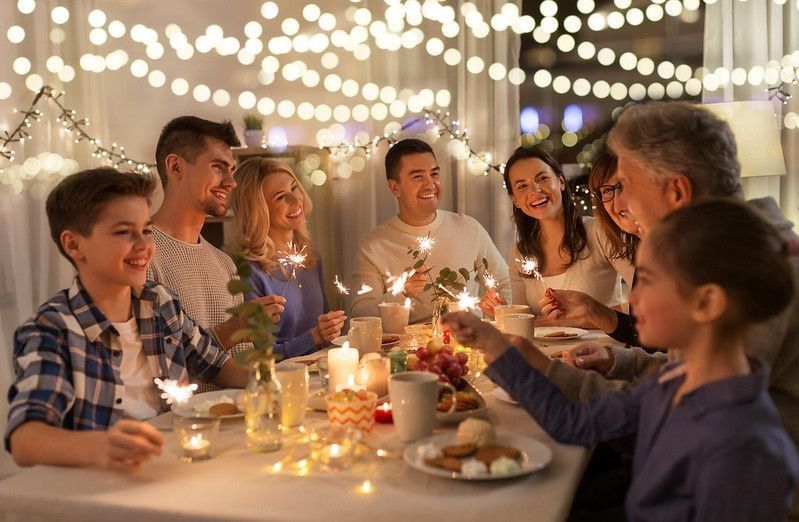 Family at dinning table with warm lights.