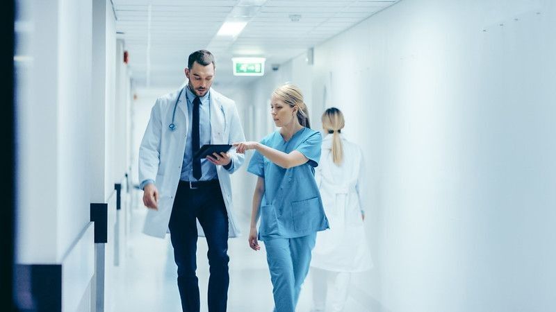 Doctor discussing while walking in the hospital.