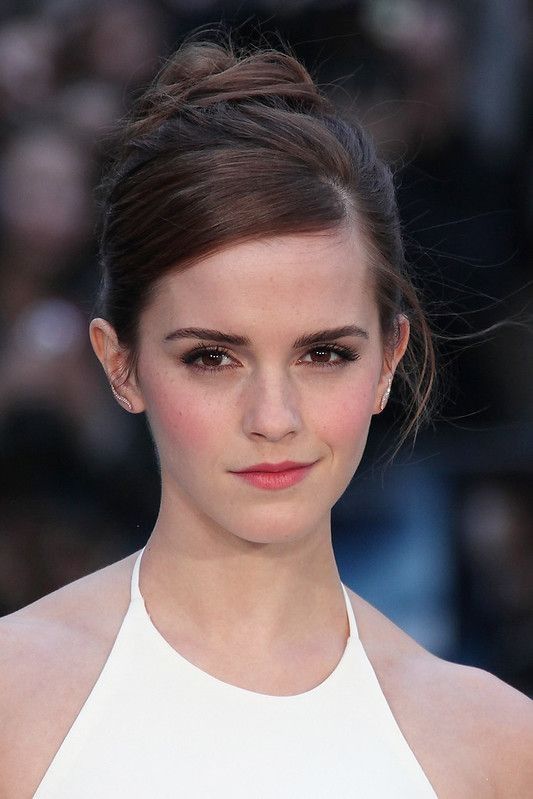 Actress Emma Watson wearing white dress.