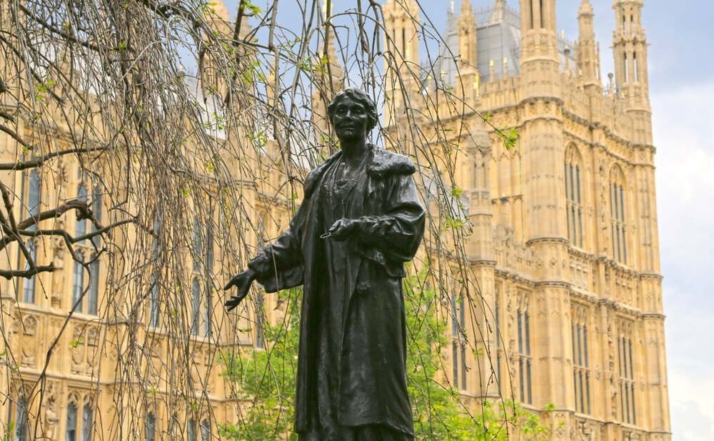  Statue of Emmeline Pankhurst, the main british suffragette, in the Victoria Tower Gardens, created by Arthur George Walker, with the Houses of Parliament