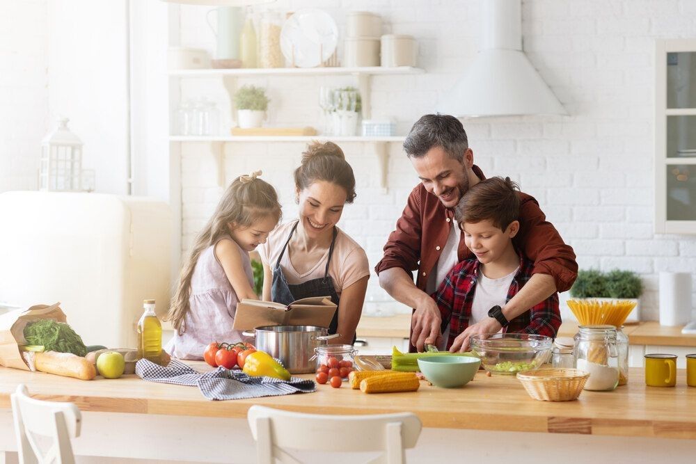 Happy family cooking together on kitchen.
