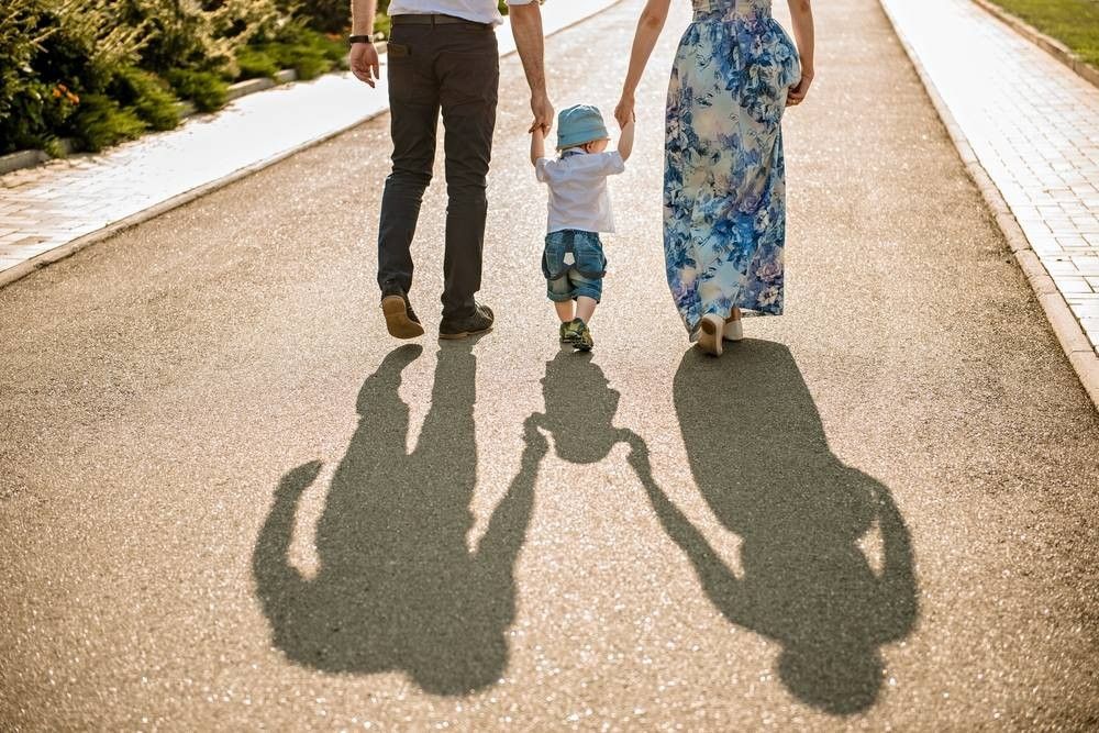 Family walking with baby. 