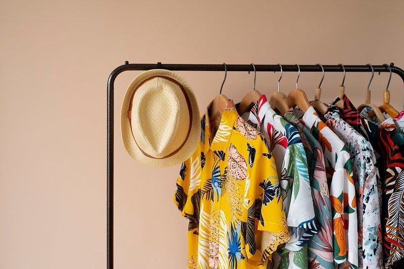 clothing rack with floral hawaiian shirts.