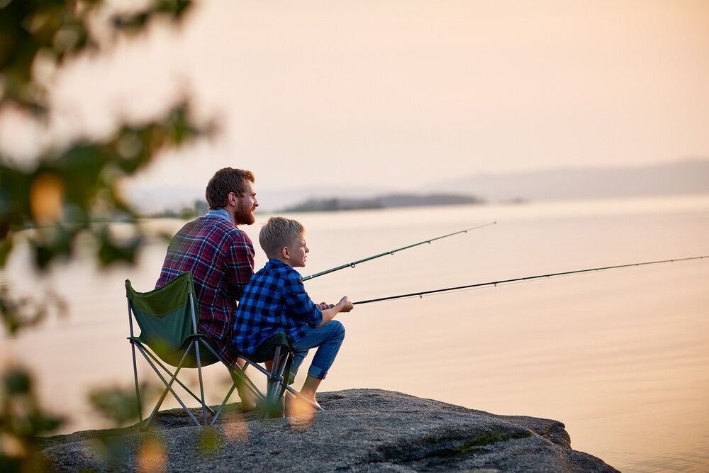 Father and son fishing on a lake side