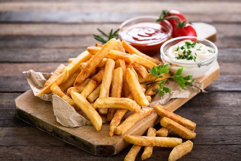 French fries on a wooden table.