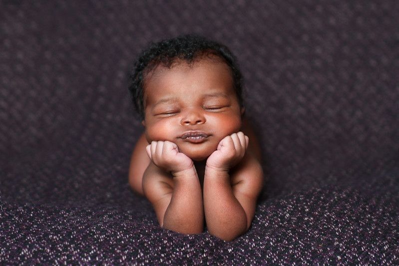 Newborn sleepy baby on a dark blanket - Nicknames