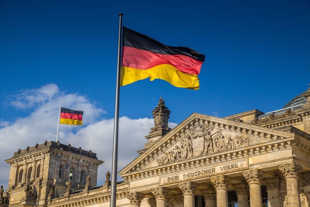 German flag hoisted on a pole in front of German parliament