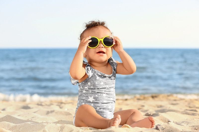 Little girl wearing sunglasses on beach