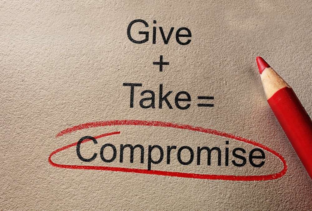 Give and Take Compromise text on paper with pencil.