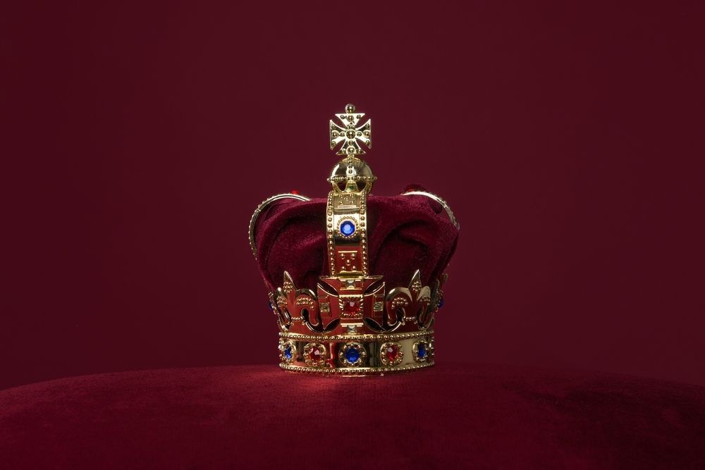 Golden crown on a velvet cushion