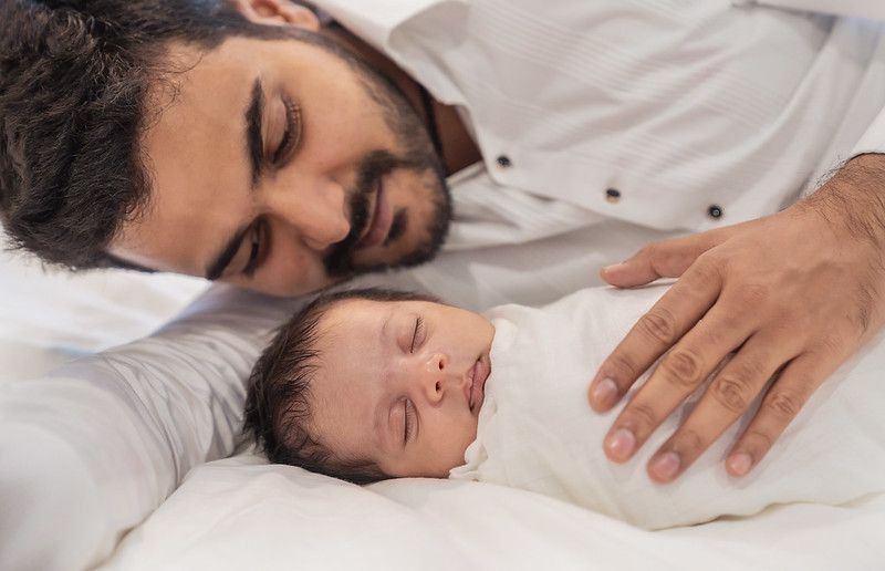 Portrait of happy Indian father with his newborn baby