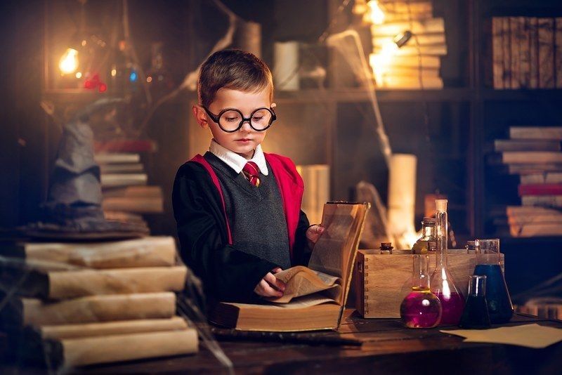 A little boy dressed as harry potter with large glasses.