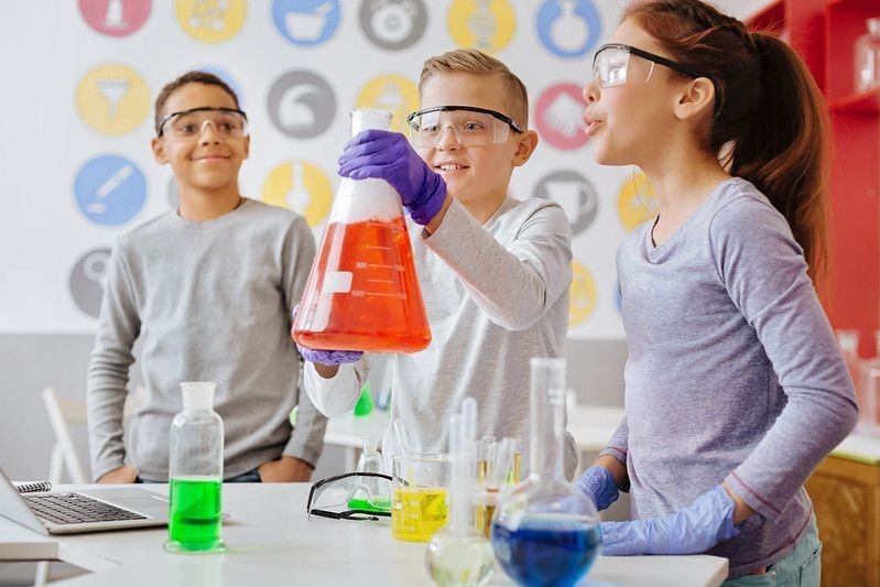 Kids experimenting with a big flask