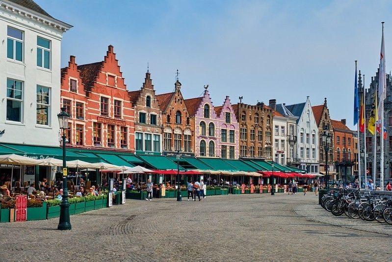Bruges Grote market square, a famous tourist place with many cafe and restaurants