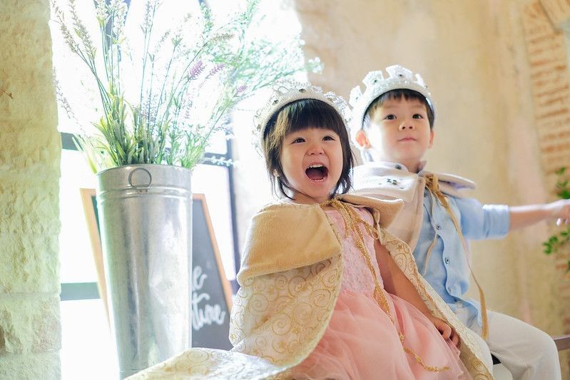 Little Girl dressed as a princess with her brother as prince.