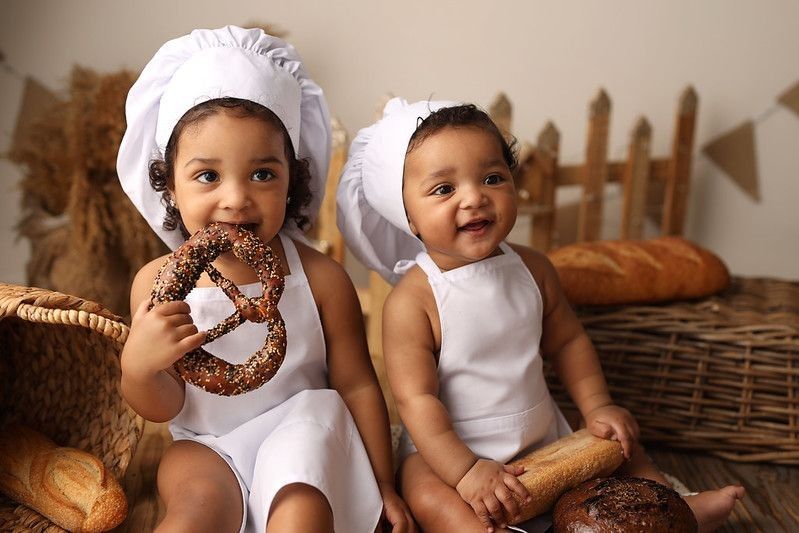 kids in a chef costume eating bread.