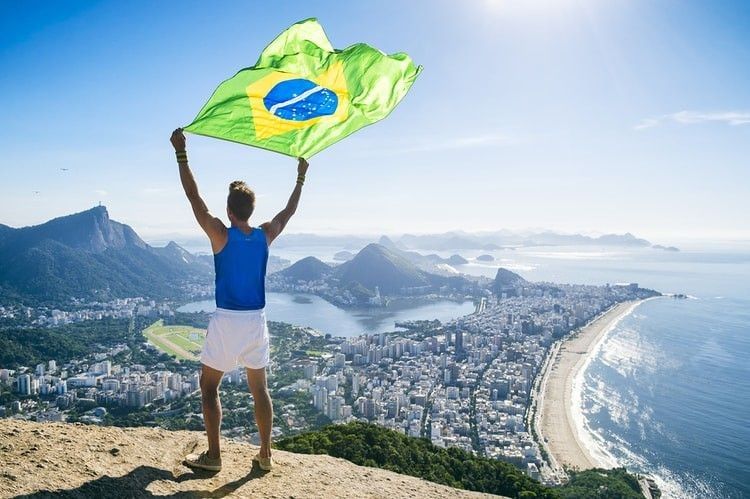 A man holding flag of Brazil