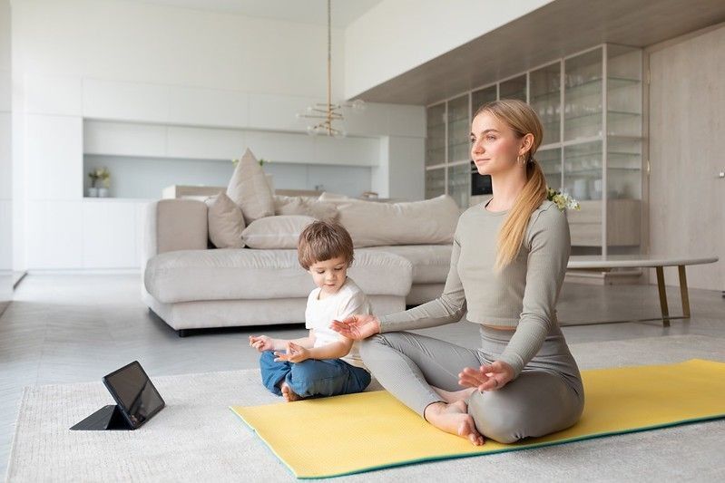 Mother and child practice yoga at home together