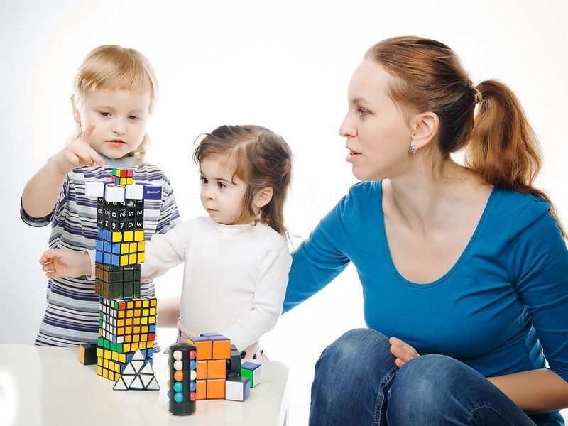 Mom and children playing rubix cubes