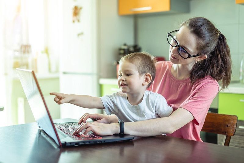Mother with kid showing coding