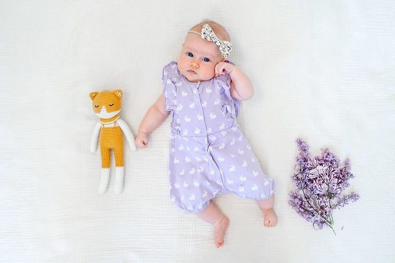A charming baby in a purple bodysuit - Nicknames