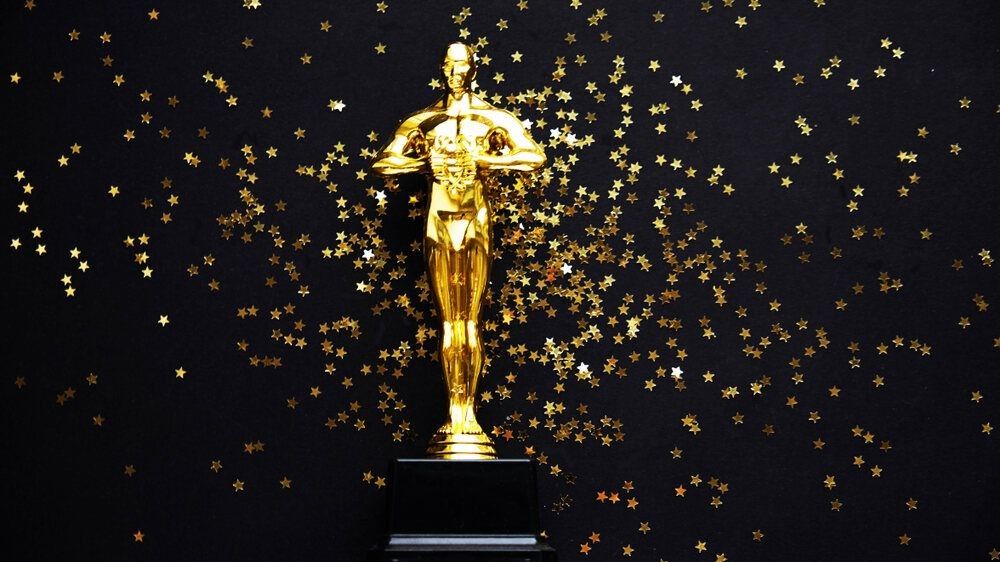 Oscar gold statue trophy on a black background