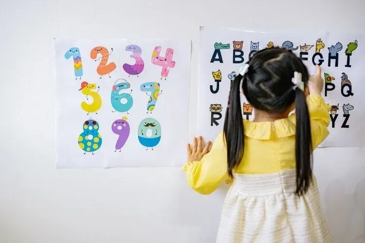 A girl learning alphabets