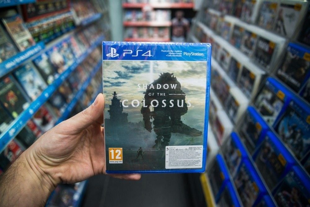 Man holding Shadow of the Colossus videogame on Sony Playstation 4 console in store.
