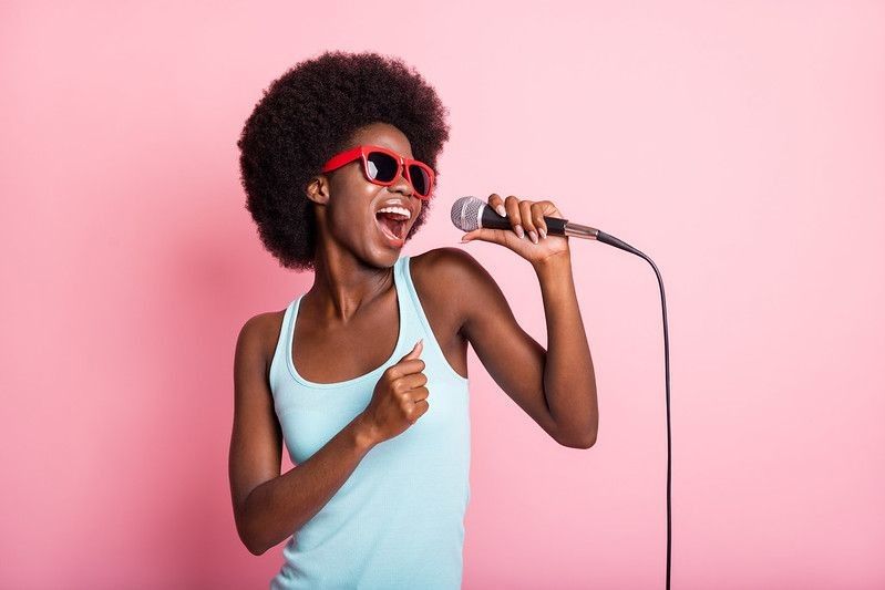 Woman with afro hair singing 
