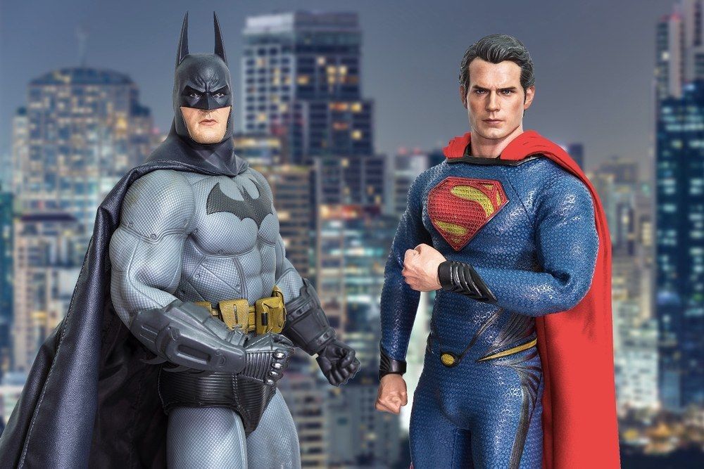Batman and Superman figure on cityscape background.