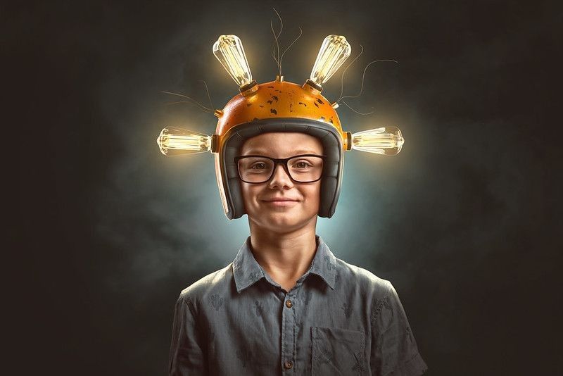  A boy with helmets and lights representing inventors