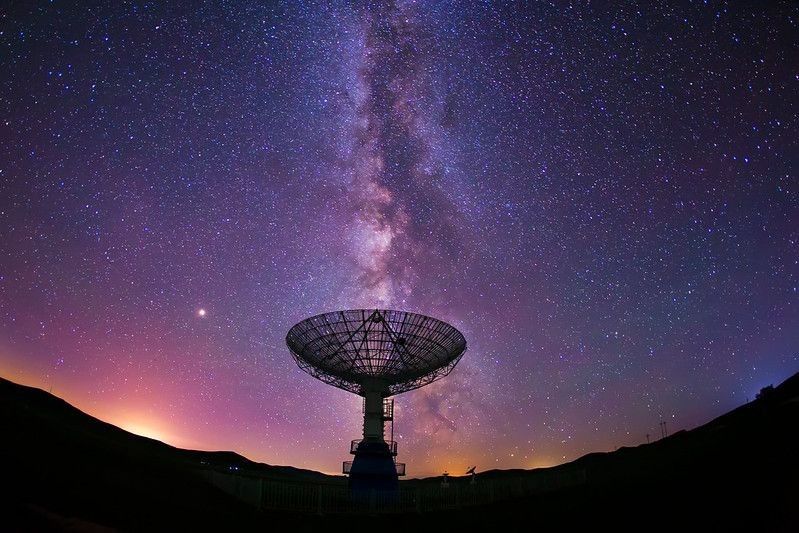 Radio telescope and the Milky Way at night