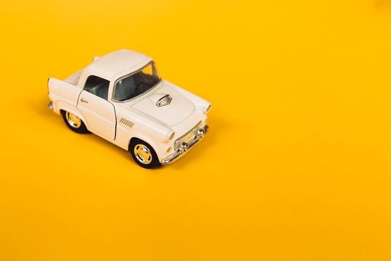 Toy car on yellow background