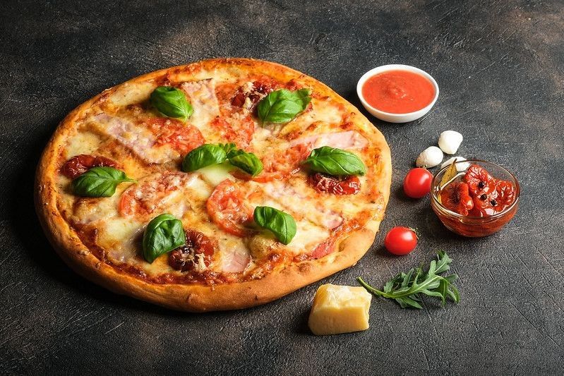 Traditional Italian pizza on a dark background