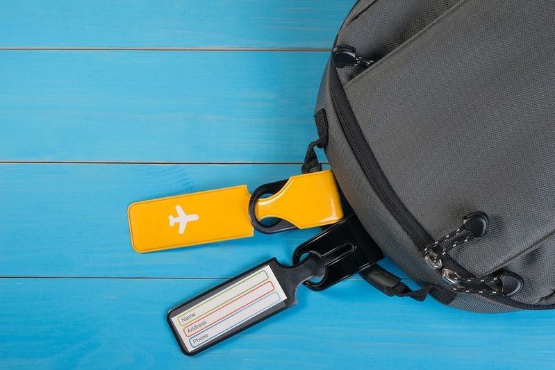 Travel luggage tag tied to a backpack