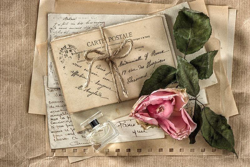 Romantic old love letters, perfume and dried rose flower.