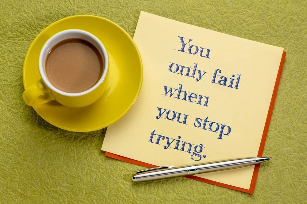 You only fail when you stop trying - inspirational handwriting with a cup of coffee.